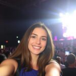 girl taking selfie at concert ai photo 701x1024